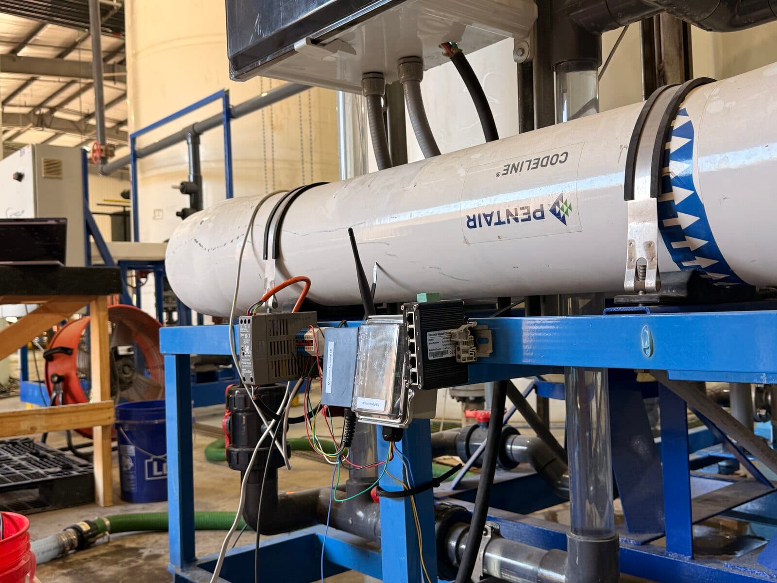 Modulink Terminal mounted on Pentair RO membrane skid at Falcon Water Tech pilot site, showing full installation with sensor wiring and CodeLine pressure vessel